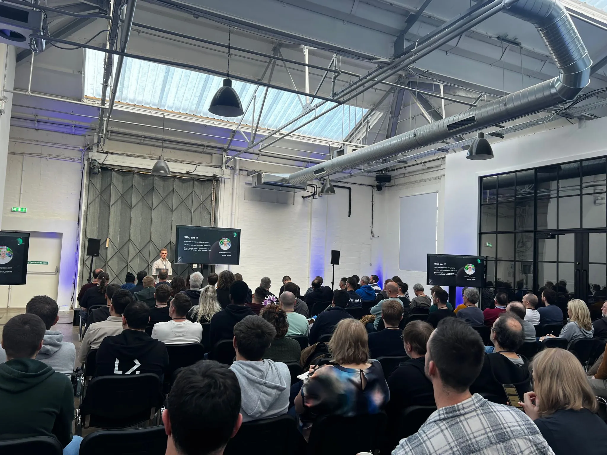 Louie speaking in front of a crowd at Umbraco UK Festival